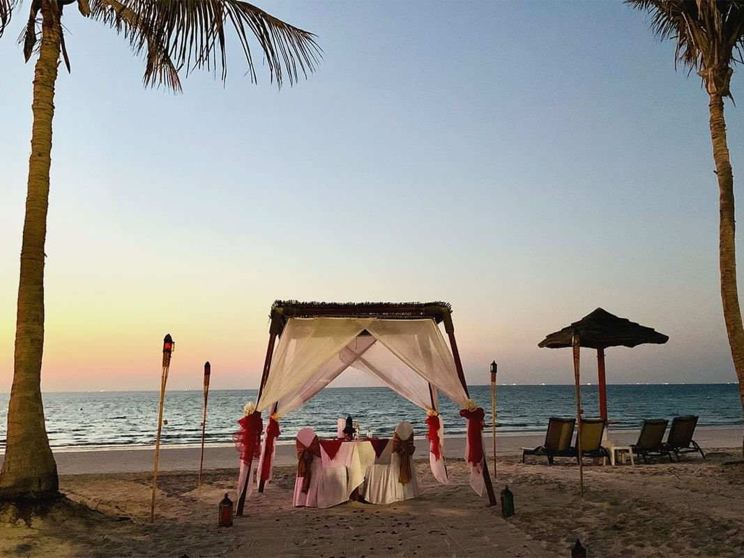Romantic dining area set up on the beach at Ajman Hotel