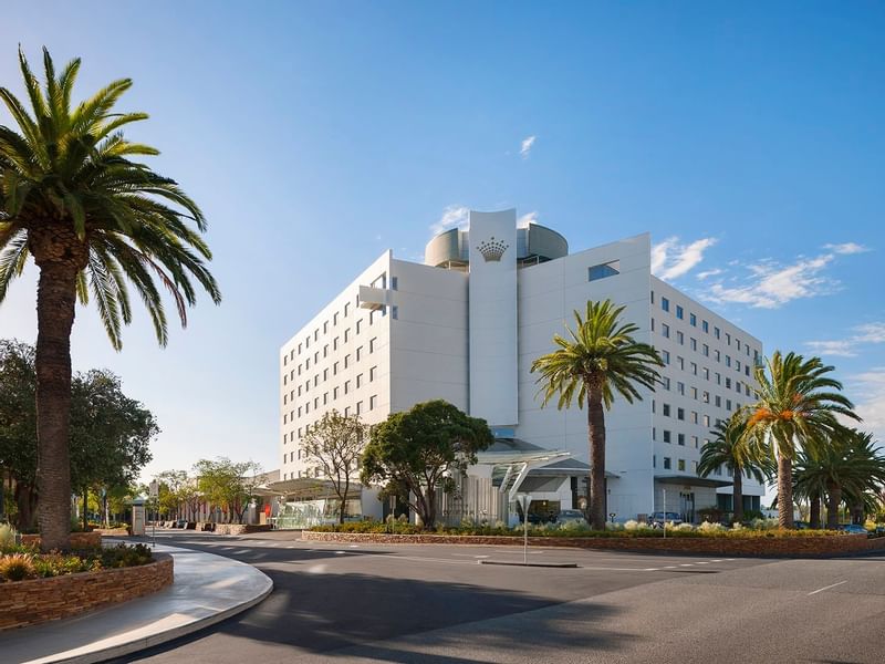 Exterior view of Crown Promenade Perth Hotel, palm trees