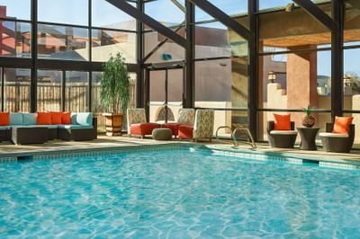 swimming pool with glass atrium and seating
