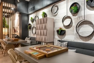 Monopoly game on the table and a lush wall decor in the lounge at The Riverwalk Plaza Hotel