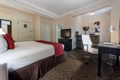 King bed with comfy pillows in a guest room at Artmore Hotel