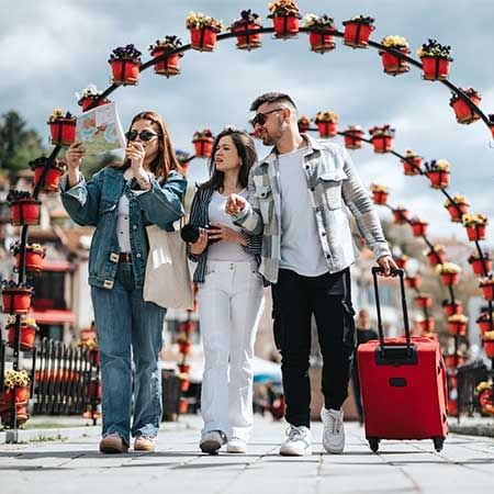 Three travelers exploring a city holding a map - Lexis Port Dickson