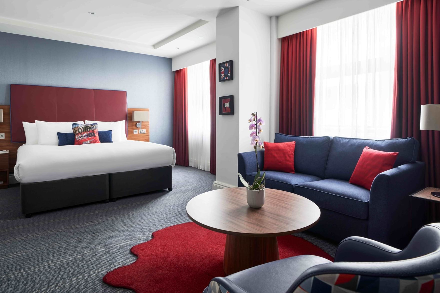 A comfy bed & sofas in Studio Suite at The Cumberland Hotel