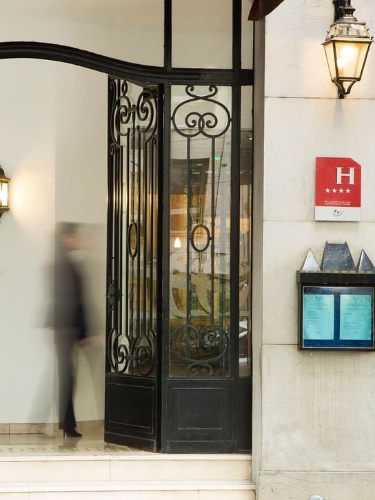 Lady walking past the entrance at Oceania Hotels Group