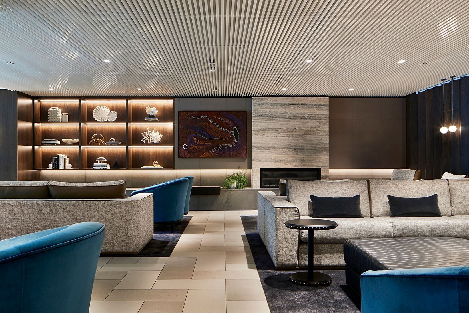 Spacious lounge area with ornaments on shelves at Quay West Suites Melbourne