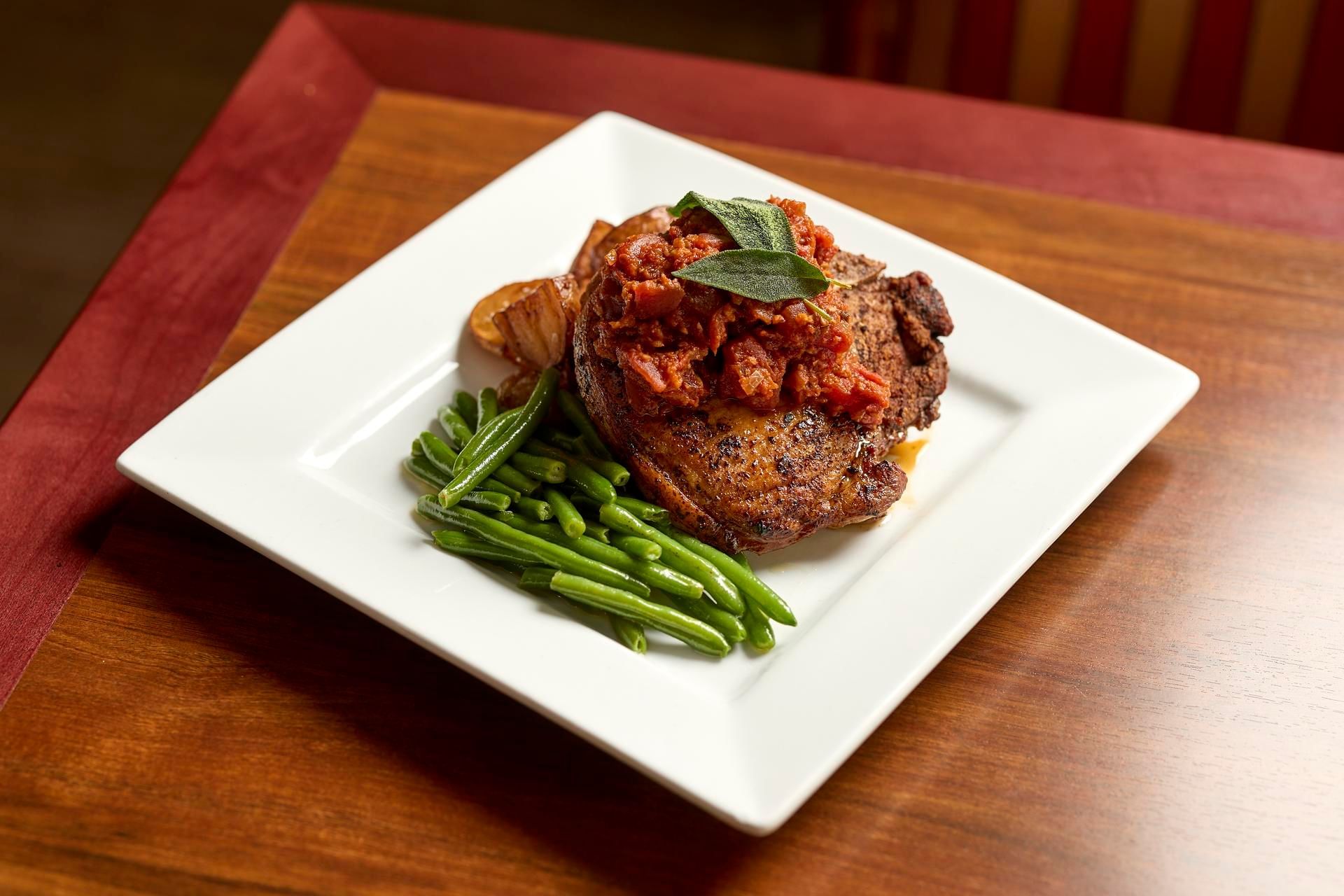 Close-up of a pork dish with beans at The IowaStater Restaurant