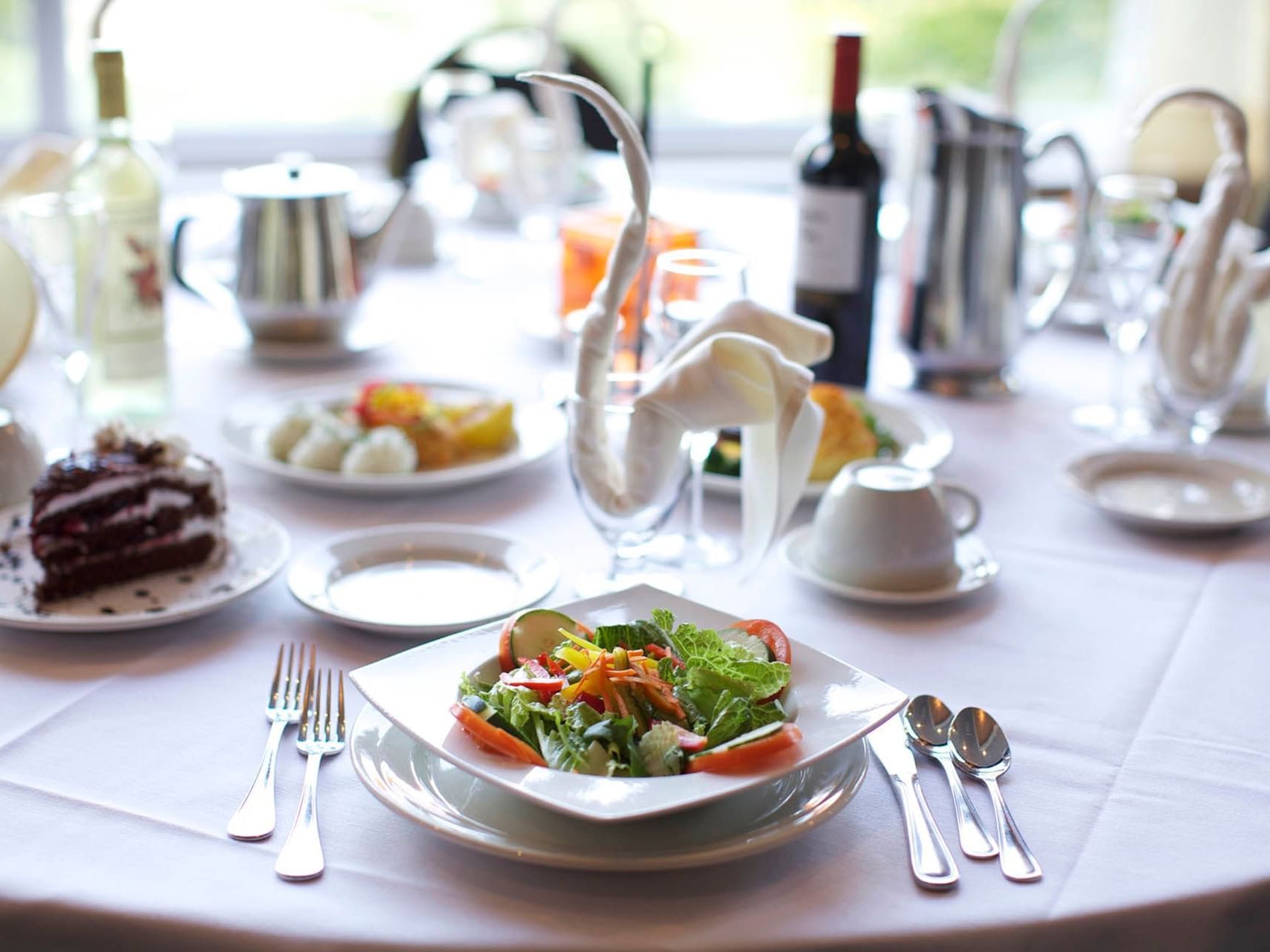 Dining table with food and wine bottle at Honor’s Haven