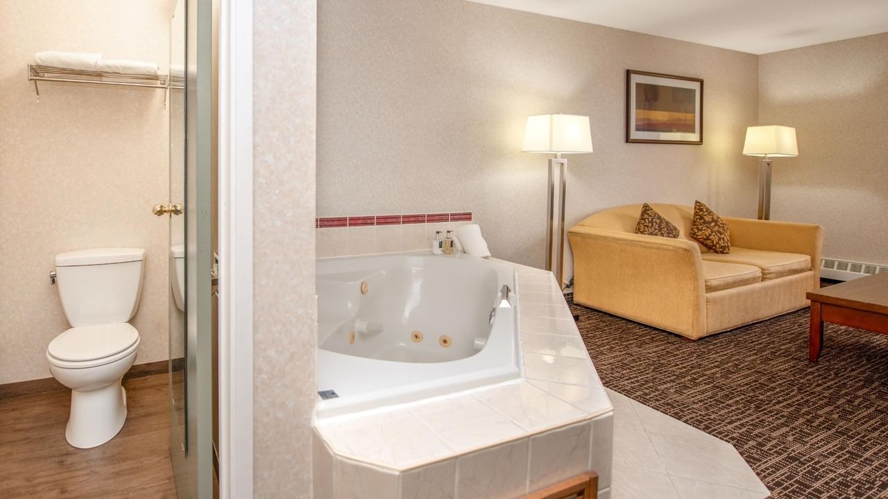 Hotel room with couch and jetted tub.