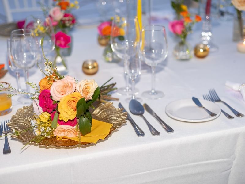 Elegantly set dining table with floral centerpiece at Fiesta Americana Riviera Nayarit Resort & Spa.