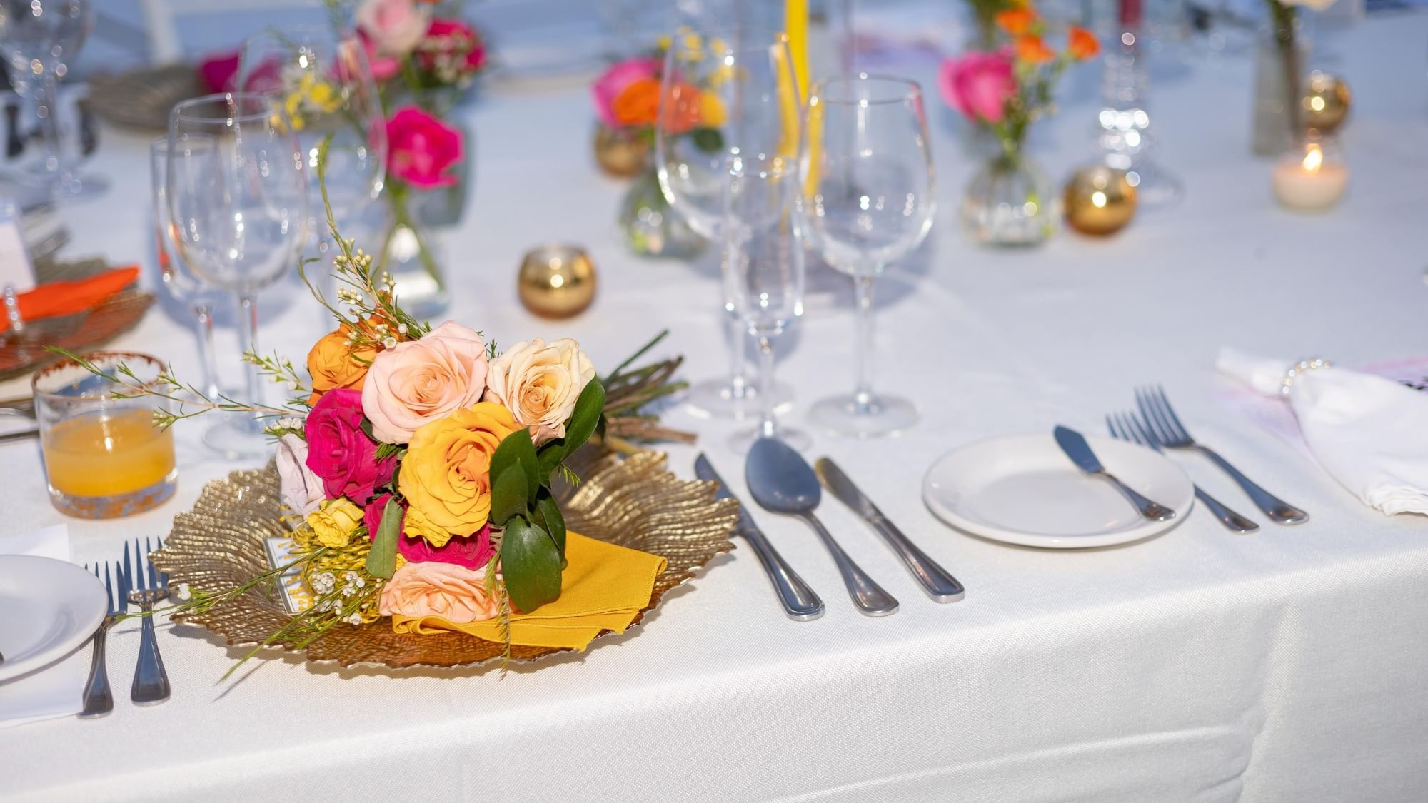 Elegantly set dining table with floral centerpiece at Fiesta Americana Riviera Nayarit Resort & Spa.