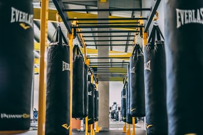 Well-equipped boxing gym with hanging punching bags at Irazu Hotel