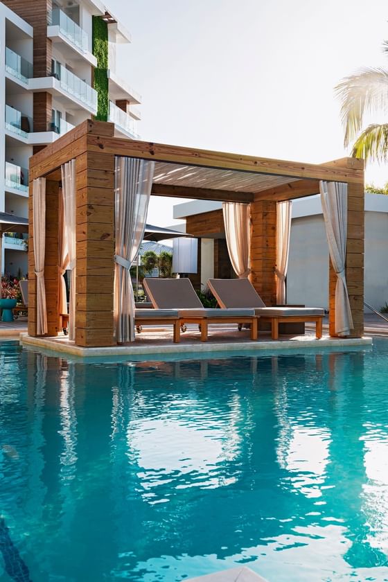 A private cabana around the Resort Pool at Alaia Belize Autograph Collection