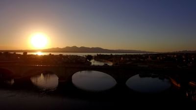Sunset view over a bridge with mountains and water in the background at London Bridge Resort