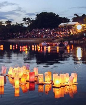 People enjoying the lantern ceremony in Japanese Garden by the lake near Ocean Lodge Boca Raton