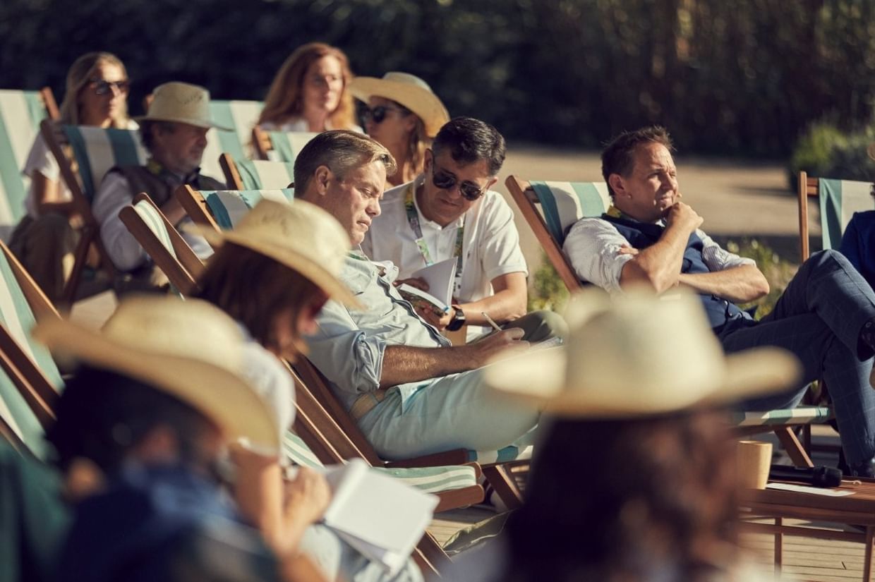 Audience in deck chairs and sun hats listening during a sunny outdoor La Concha Conversations at Marbella Club