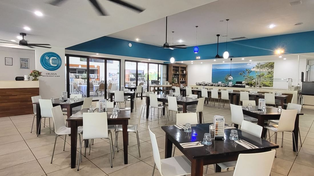 Tables and chairs inside the air-conditioned dining area at Celsius Restaurant & Bar