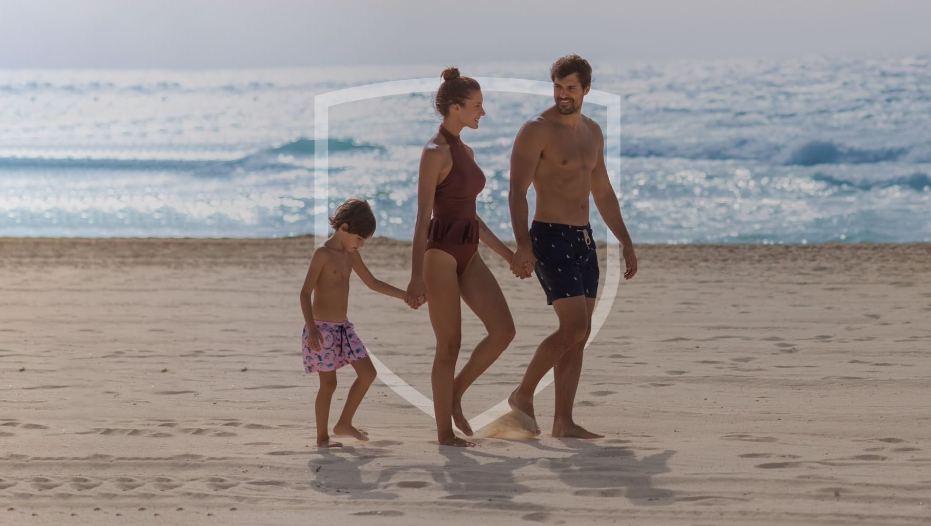 Family walking on the beach while enjoying the sun at The Explorean Resorts