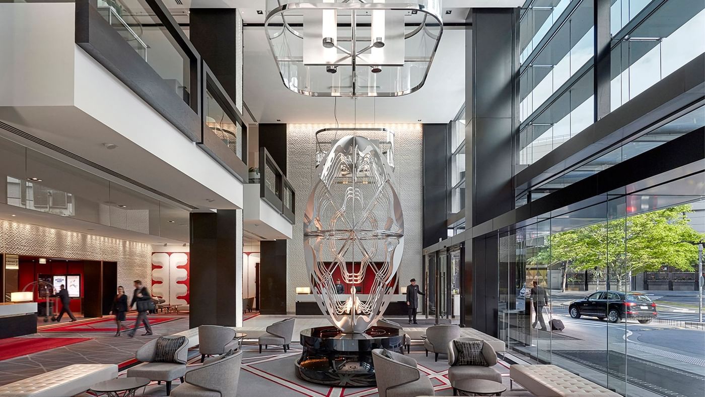 Modern interior of lobby with artistic chandelier, sleek furniture featuring Relax at Crown Hotels