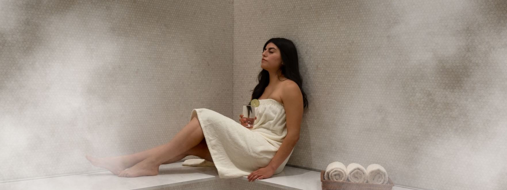Woman relaxing & enjoying the Spa Sauna in Warwick Melrose Dallas