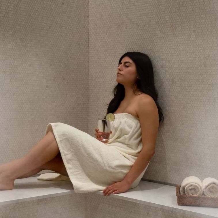 Woman relaxing & enjoying the Spa Sauna in Warwick Melrose Dallas