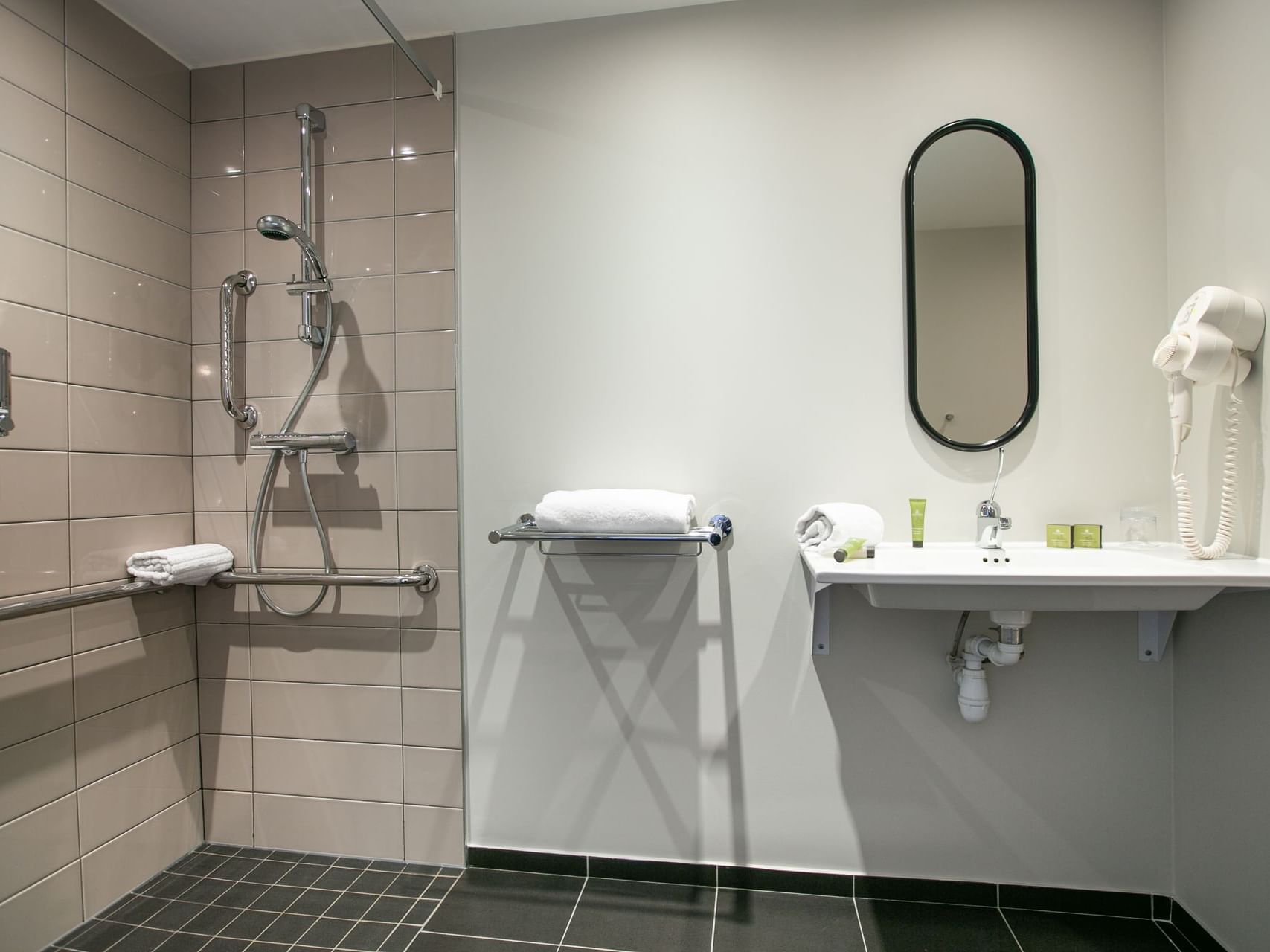 Shower area by the bathroom vanity in PMR Comfort Room at Hotel Saint James