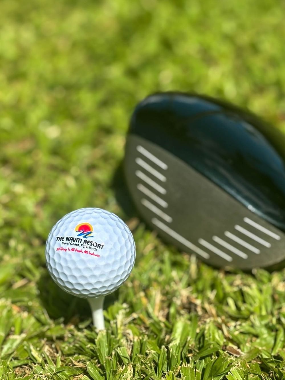 Golf ball and club on grass at The Naviti Resort in Korolevu.