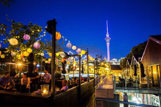 Auckland Sky tower & City Center at night with vibrant landscape illuminated by colorful lights