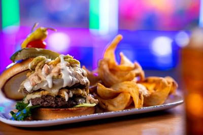 Gourmet double-stack cheeseburger topped with special sauce and fried onions in the Hippie Fish at Centennial Plaza Resort