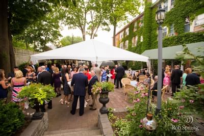 People at an outdoor event in the courtyard at Inn at Saratoga