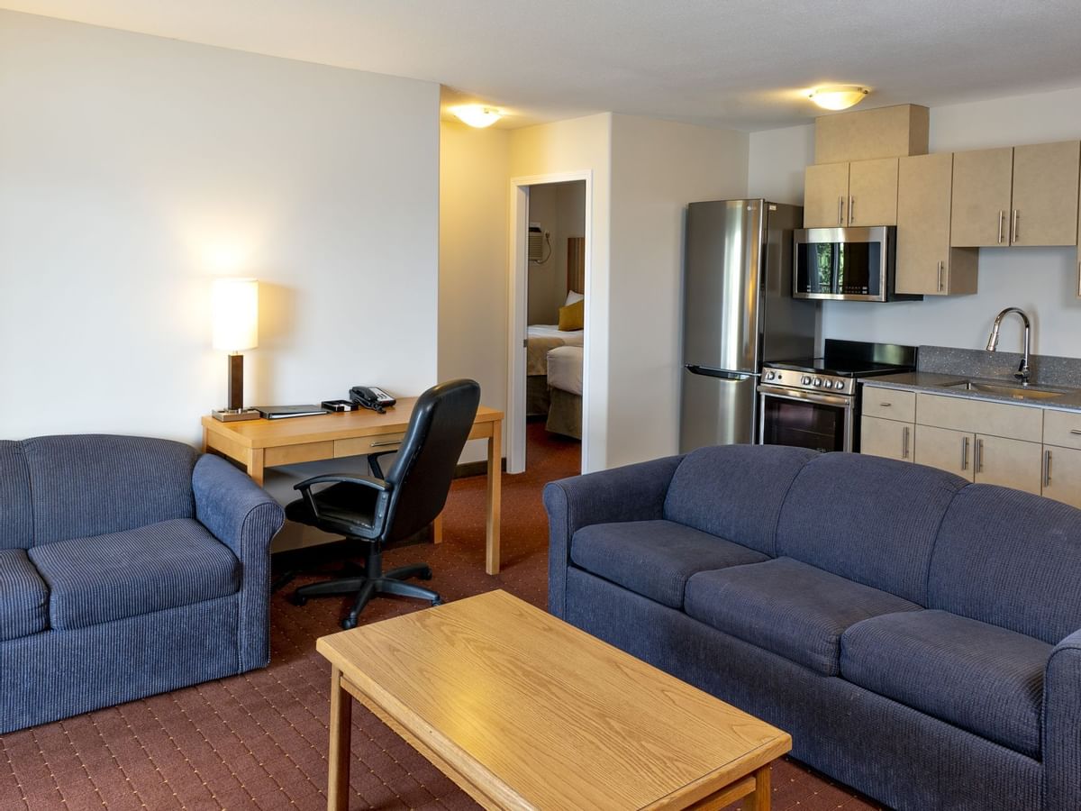 Sofas and table in living room of hotel suite
