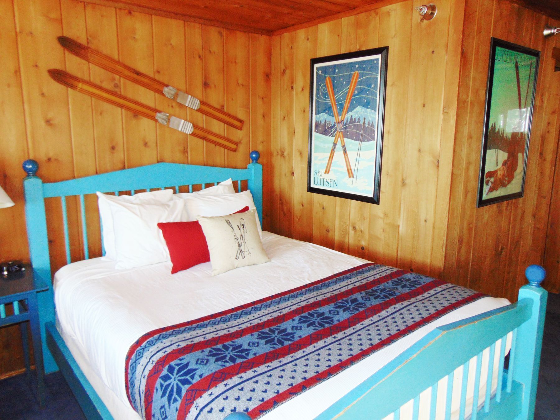 bed in a cabin with ski decorations