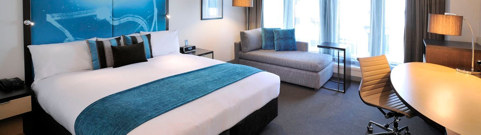 Interior of room with king bed at Novotel Melbourne on Collins