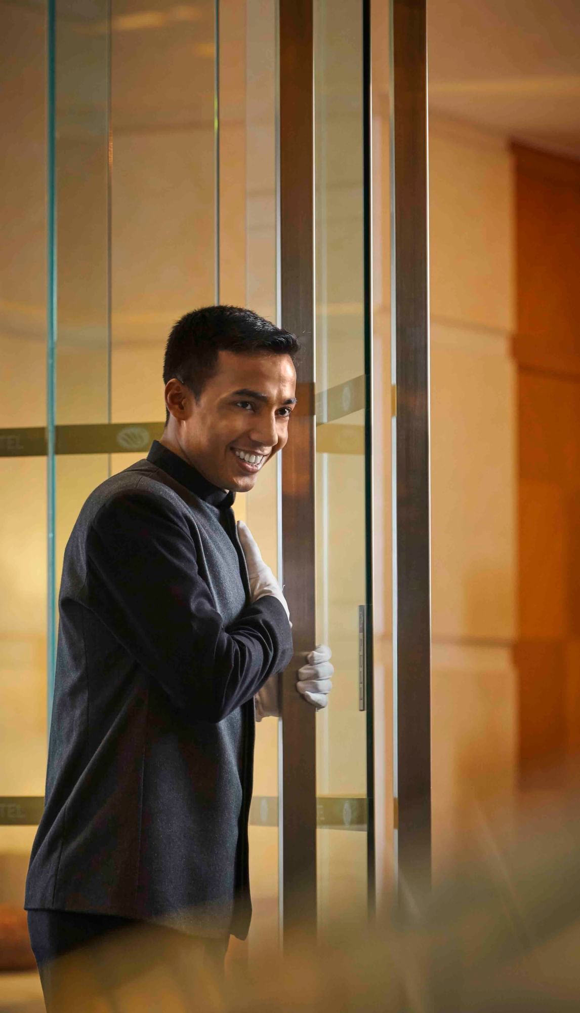 Concierge staff opening door to greet guests at Sunway Hotels & Resorts