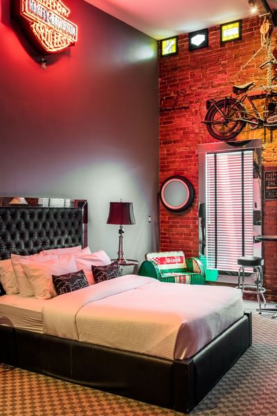 Harley Davidson neon signboard, comfy bed & vintage motorbike in Queen Premiere Easy Rider at Retro Suites Hotel