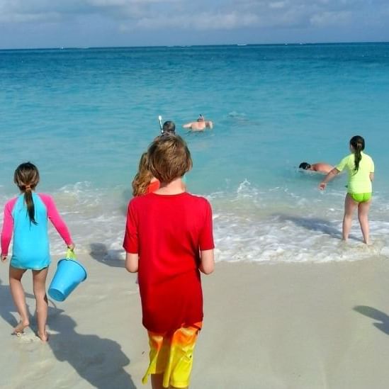 Kids playing on the beach near The Somerset On Grace Bay