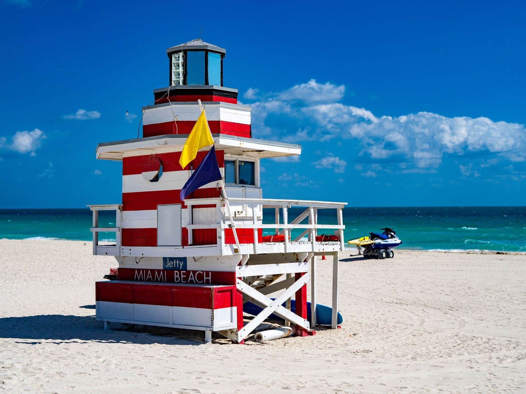 Iconic red and white striped lifeguard tower on the sunny sands of Miami Beach near the wonderful Tradewinds Apartment Hotel
