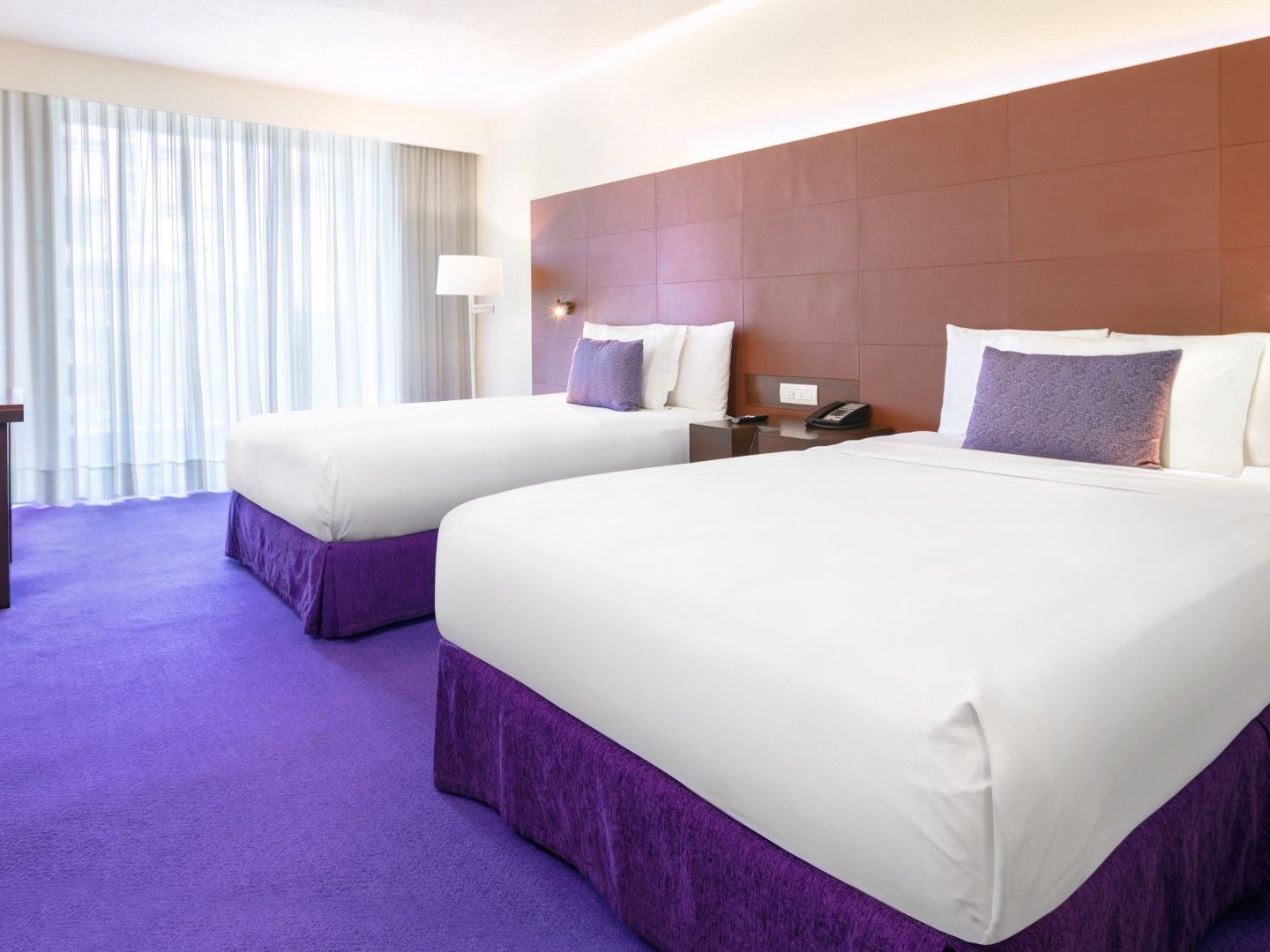 2 Double Camino Real Club with a reddish-brown paneled wall and vibrant purple carpet at Camino Real Polanco Mexico