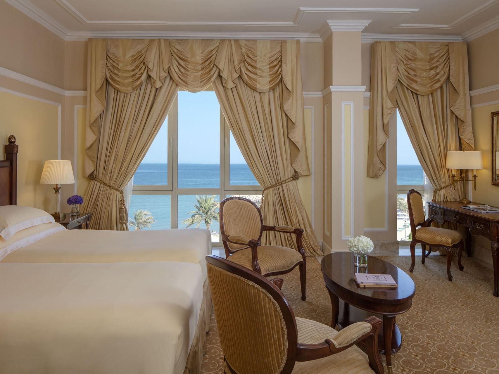 King bed in a suite with a sea view at The Regency Hotel