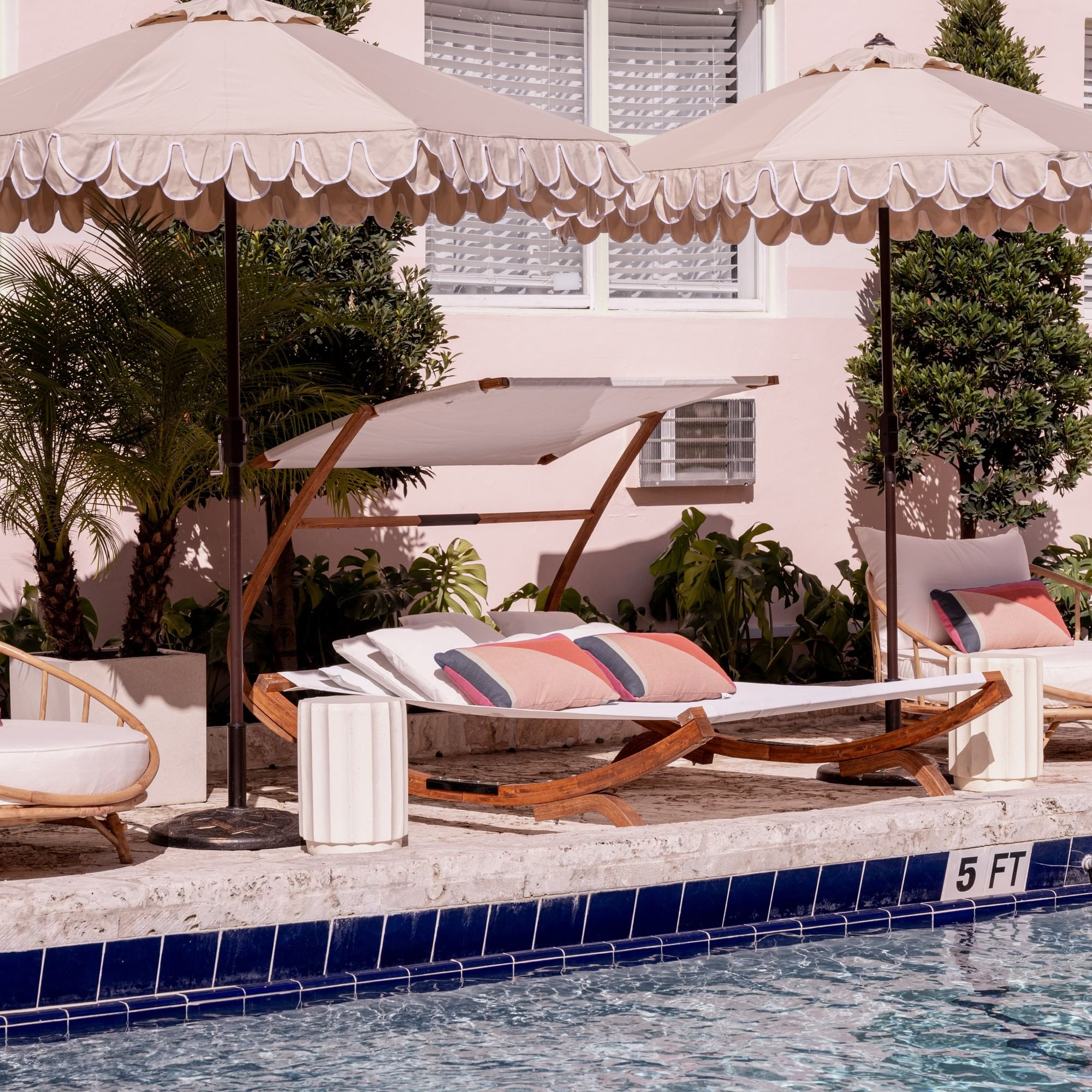 A poolside scene with lounge chairs and umbrellas