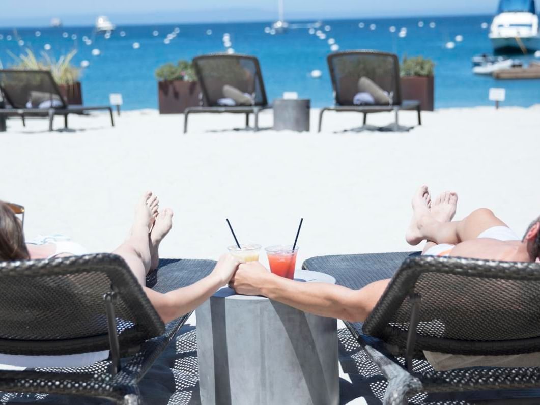 A couple relaxing on the beach in Harbor Sands at Two Harbors at Inn at Mt Ada