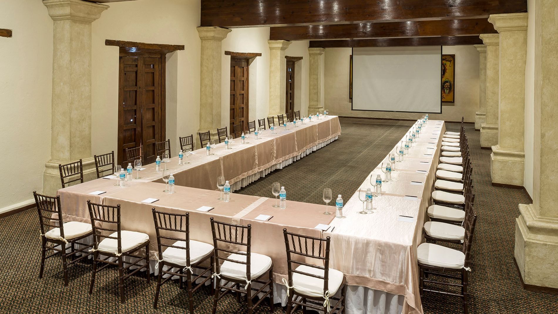 San Pedro with long tables, water bottles, and a projector at Quinta Real Zacatecas