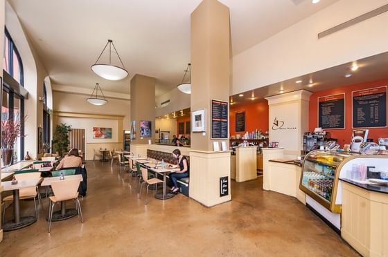 Spacious coffee shop with modern decor and patrons seated at tables at Pickwick San Francisco