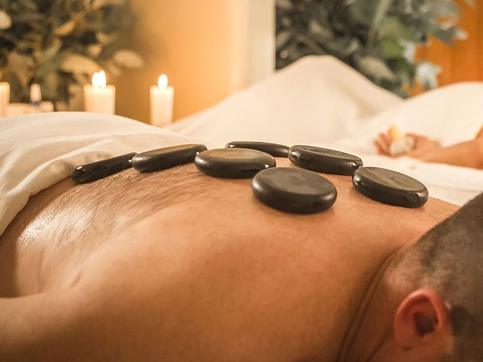 A client having Massage with andean hot stones at Hotel Sumaq