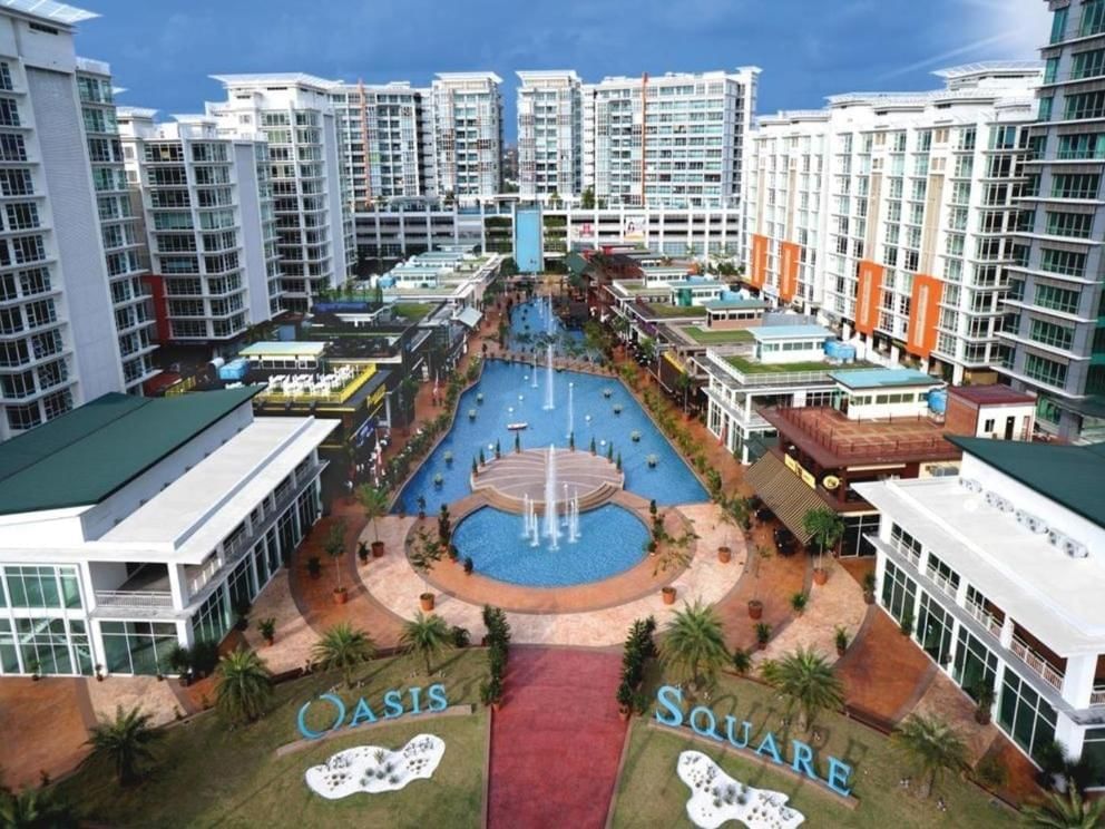 Aerial view of Oasis Square featuring modern buildings and central lake with fountains near Saujana Hotel Kuala Lumpur