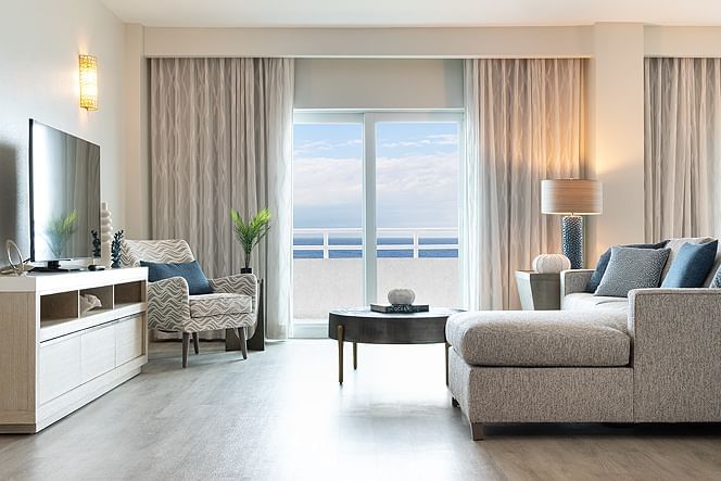 Ocean front suite with TV and couch at Ocean Place Resort