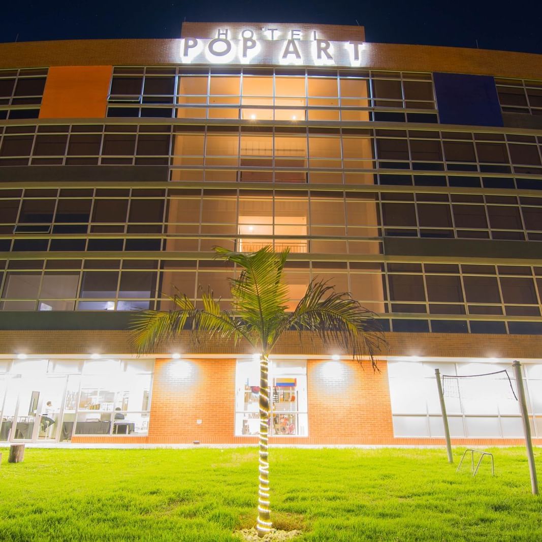 An exterior view of the hotel at night of Pop Art Tocancipa