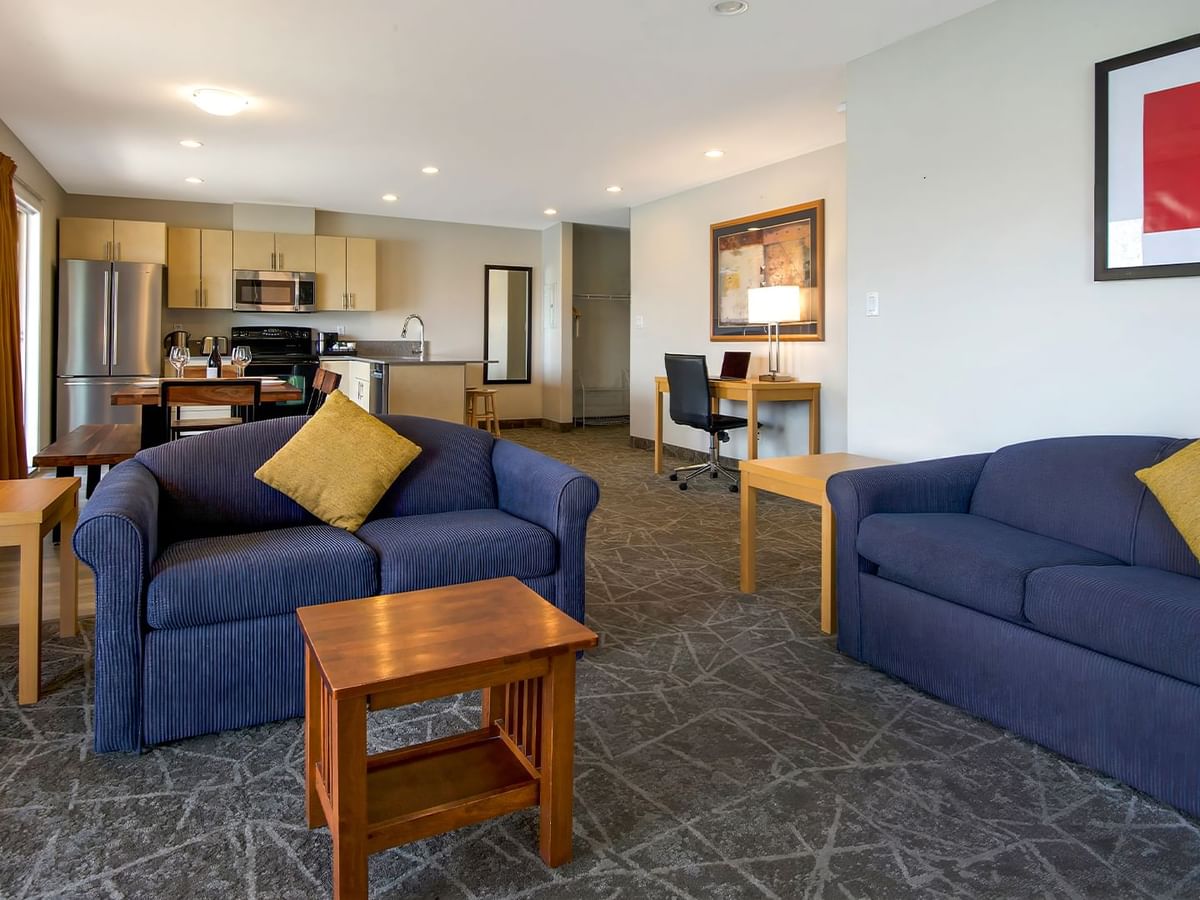 Sofas and kitchen of hotel suite