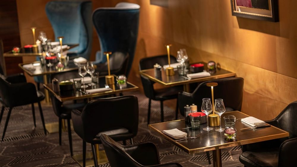 Elegant dining tables with black chairs at Restaurant Le W in Paris at Warwick Champs-Elysées.
