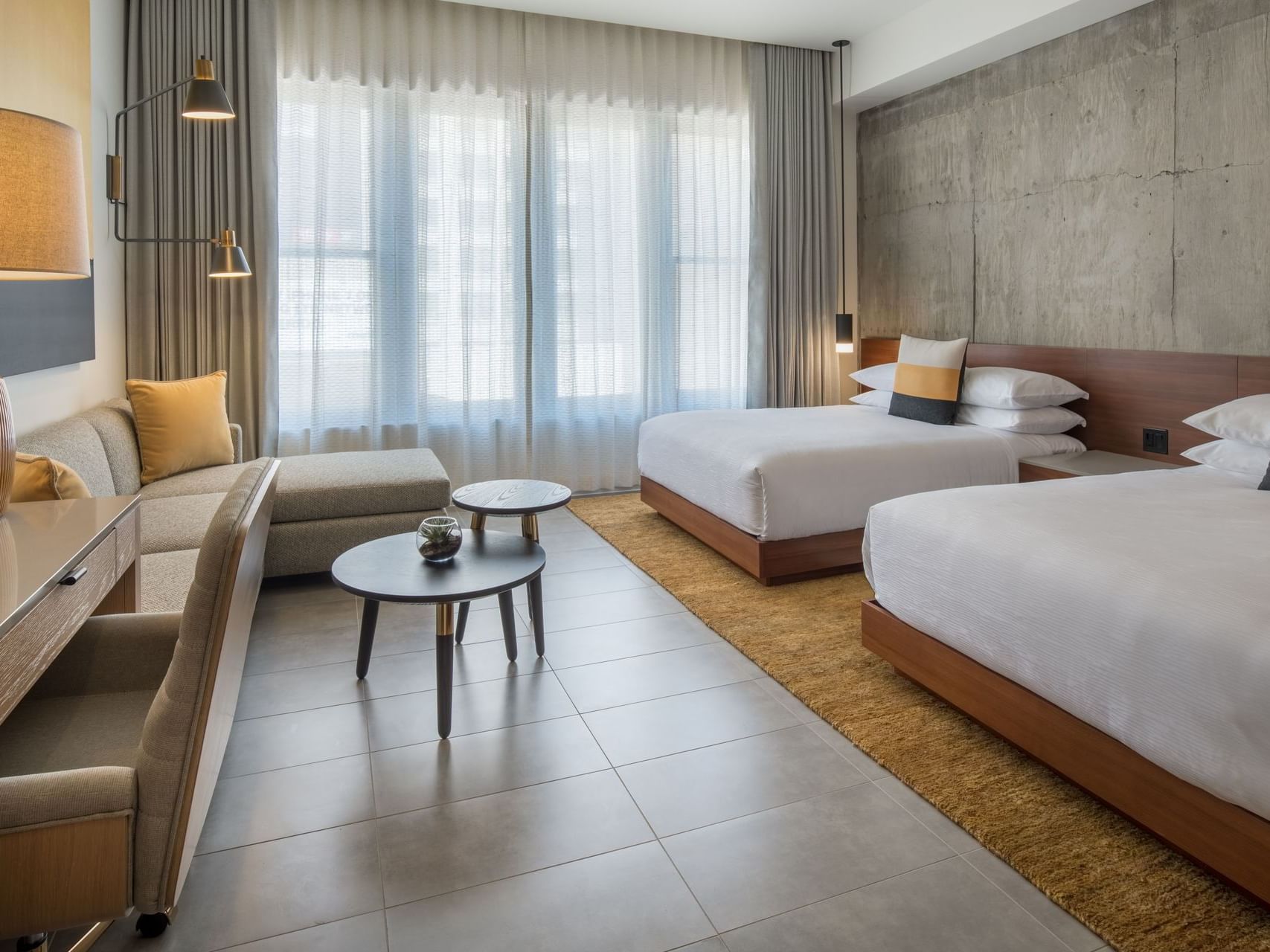 Hi-Lo hotel room with two bed and sectional