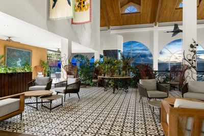 Lounge area with tropical decor, patterned floor, and large windows at Gamboa Rainforest Resort